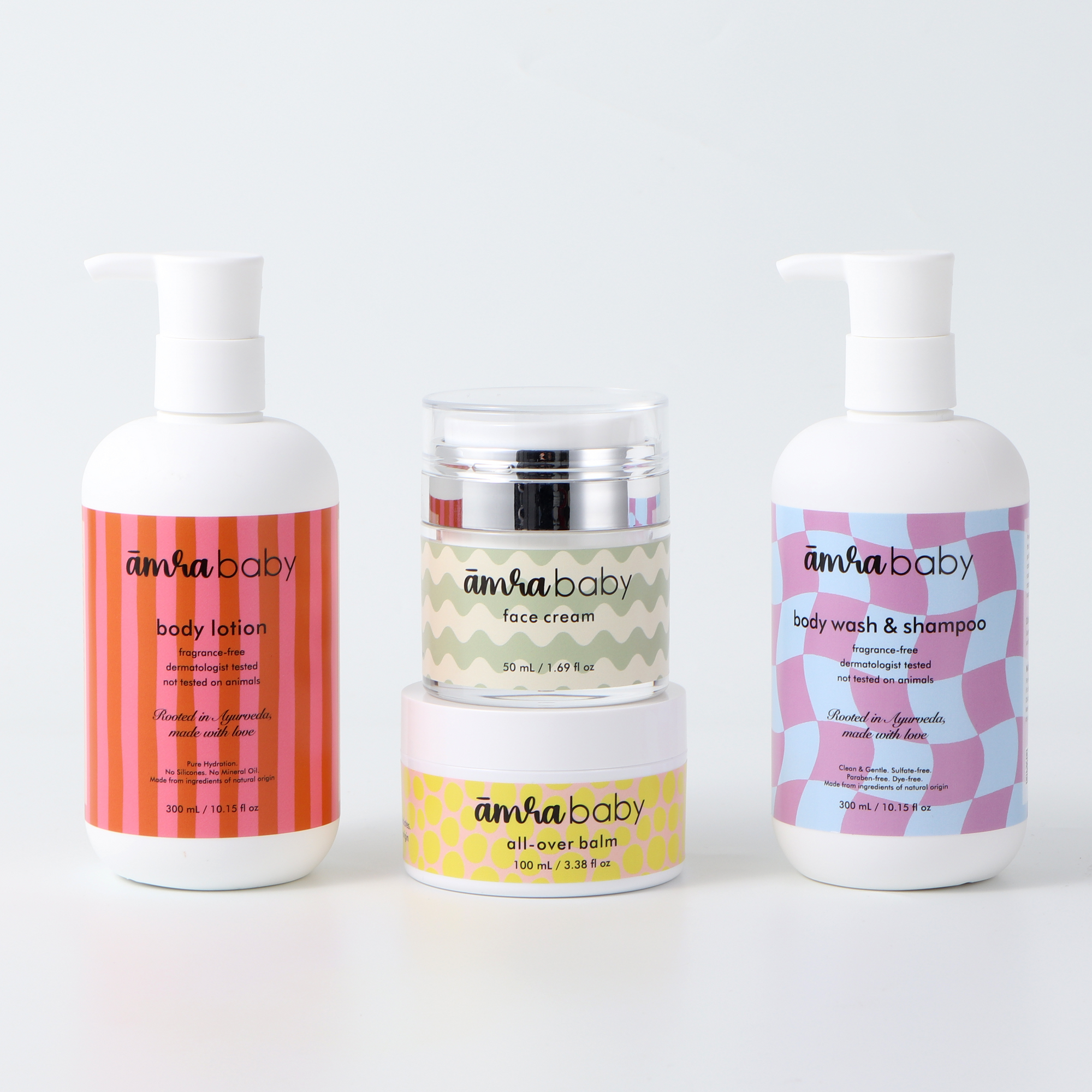 Amra Baby ayurvedic baby skincare bundle including body lotion, face cream, body wash & shampoo and All-over balm on a white background