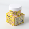 Amra baby All Over Body Balm jar resting on top of its yellow and pink patterned box
