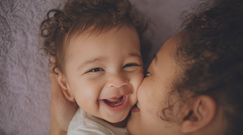 Mom playfully snuggling with her baby